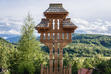 Traditional Maramures carved wooden cross in monastery in Barsana village, located in Maramures County of Romania