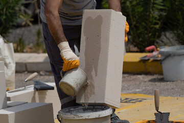 The bricklayer is working. Building a wall of aerated concrete. Gasbeton wall