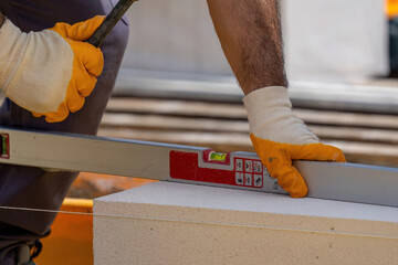 The bricklayer is working. Building a wall of aerated concrete. Gasbeton wall