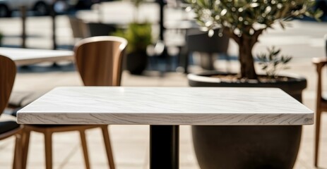 Fototapeta premium Modern outdoor cafe table with marble top and wooden chairs