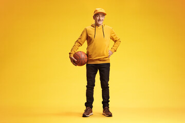 Cool senior man holding a basketball