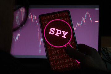 Hacker spying datas on a smartphone, pirate attacking a phone privacy and security.