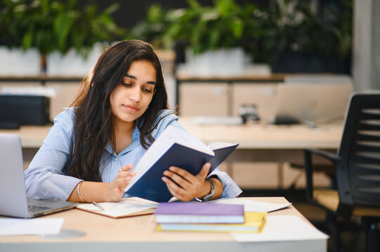 Indian woman student studying in modern office environment