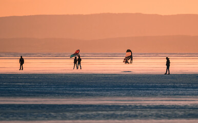 silhouette of people skating and walking on frozen Neusiedl lake