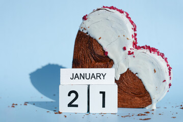 National hug day 21 January wooden calendar cubes wishes greeting holiday card Heartshaped pastry croissant treat topped with colorful frosting galore. Food experimentation viral dessert creative