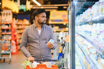 Man shopping for dairy products in supermarket