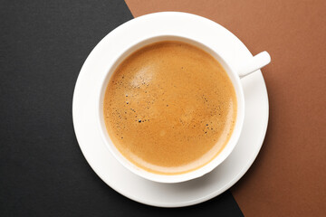 Fototapeta premium Aromatic coffee in cup on color background, top view