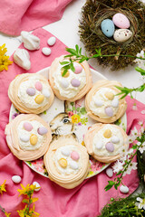 Easter meringue nests with whipped cream and decorative chocolate eggs