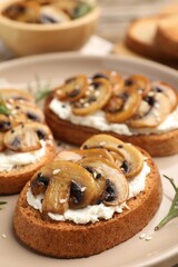 Tasty bruschettas with cream cheese, mushrooms, rosemary and sesame seeds on table, closeup