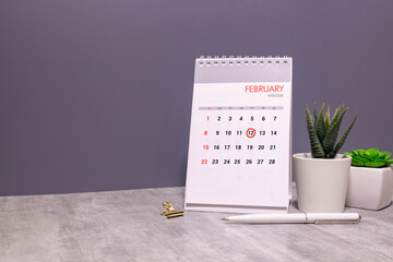 calendar displaying FEBRUARY 12 with light grey background.