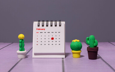 calendar displaying FEBRUARY 12 with light grey background.