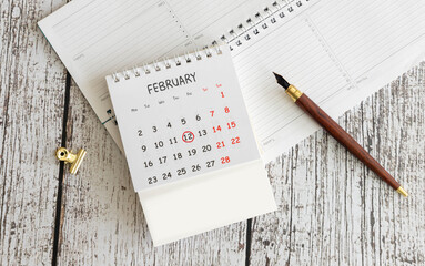 calendar displaying FEBRUARY 12 with light grey background.