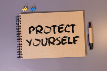 there are yellow paper clips and a sheet of paper with the inscription - PROTECT YOURSELF