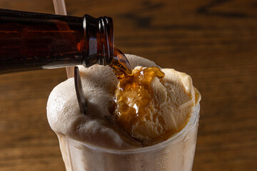 Root beer poured onto drink