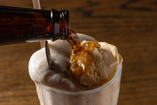 Root beer poured onto drink