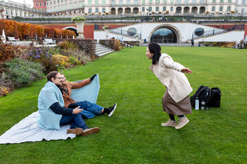 Friends enjoy a relaxed moment together in the park on a sunny day in autumn