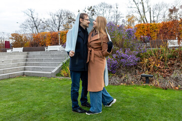 Couple enjoying time together in the park during autumn season with colorful trees
