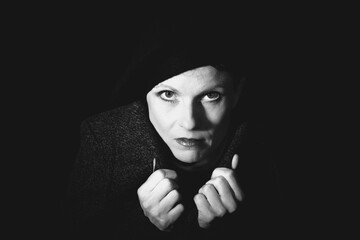 Dramatic black and white portrait of woman in low key lighting
