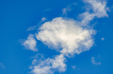 Fototapeta premium Single White Cloud Against Bright Blue Sky