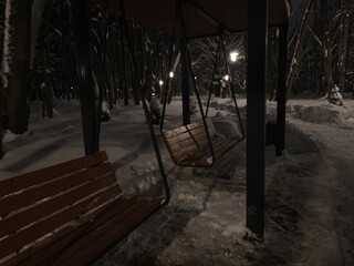 Bench in the dark winter park
