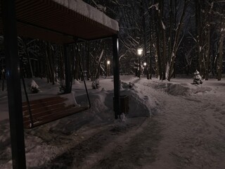 Bench in the dark winter park