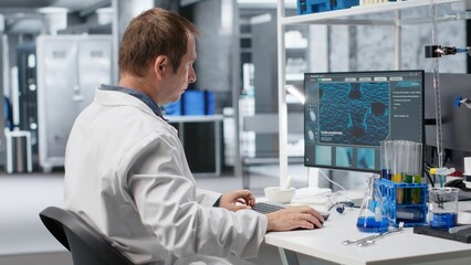 Chemist unable to comprehend results of clinical diagnostics, appears displeased and unsuccessful in laboratory workspace. The hard reality of science and advanced medical research.