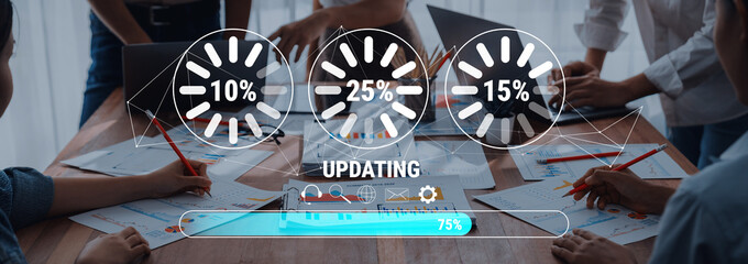 Diverse team members engage in a business meeting, showcasing progress indicators and collaborative efforts in data updates and strategic planning. Trope