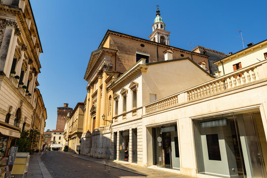 Narrow tunnel street in Vicenza, northeast Italy. Immutable row of buildings on both sides of street forms narrow passage, paved pavement of ancient city..
