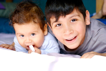 Latin baby with big brother.