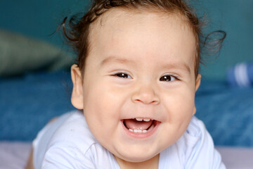Latin baby laughing sweetly. 
