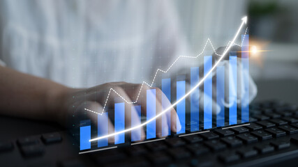 A business professional engages with technology, typing on a keyboard while a futuristic growth...