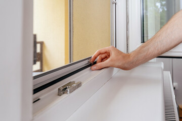 Expert repairman installing a pvc window frame in a residential building
