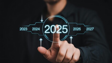 Man selecting 2025 on futuristic interface with blue glow in dark modern lighting for technology