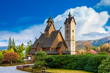 Medieval Norwegian wooden church Vang or Wang and Snezka mountain in the background. Karpacz, Poland