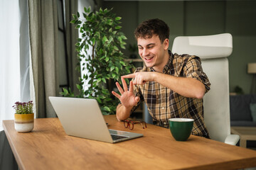 Young man communicating in sign language on video call