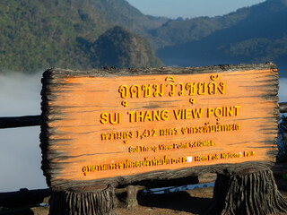 View of the mountains and sky with sign board of Sui Thang Viewpoint at Doi Pha Hom Pok National Park in Chai Prakan district of Chiang Mai province.