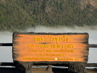 View of the mountains and sky with sign board of Sui Thang Viewpoint at Doi Pha Hom Pok National Park in Chai Prakan district of Chiang Mai province.