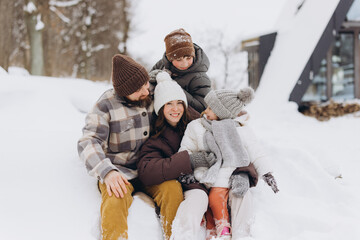 Happy family enjoying winter vacation in snowy landscape