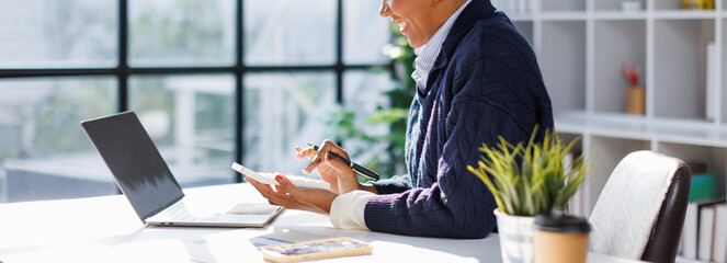 Business in afro hair businesswoman using calculator to calculate and record company marketing...
