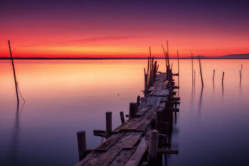 Traditional wooden stilt pier at sunrise