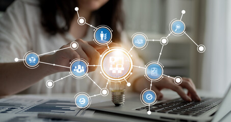 A business professional engages with a laptop, surrounded by dynamic technology graphics, symbolizing innovation and creativity in a modern work environment. Crux