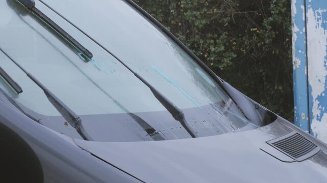panel van vehicle, close up windscreen washers, noisy servo motors, water pumps, washes glass, sync audio