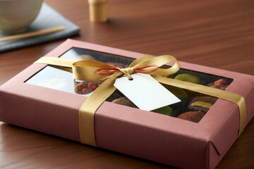Macro shot of an elegant Japanese candy and chocolate box, soft lighting emphasizing textures and warm holiday presentation.