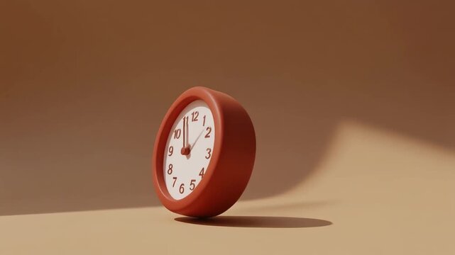 Red alarm clock standing alone on a beige surface with a shadow cast beside it in a softly lit room