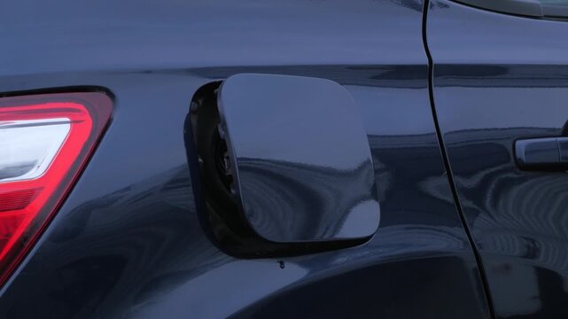car fuel cap, 2012 suv vehicle, mechanical fuel cover door operated, pops open with a pop sound