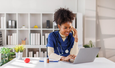 Happy friendly young woman doctor, nurse, medical worker, reception specialist in blue uniform with...