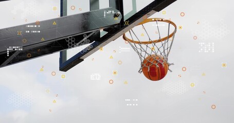 Descending orange basketball passing through net at outdoor court, with rim, overlay, copy space