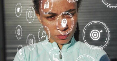 Focusing woman facing metal shutter under harsh sun, wearing turquoise zip jacket, showing AR icons