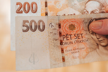  Czech Republic currency.Five hundred and two hundred Czech crown banknotes in hands, close-up. Hands count Czech money. Cash crown banknotes close-up. 