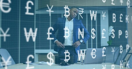Standing man in navy suit contemplating at conference table, with notebook and currency overlay
